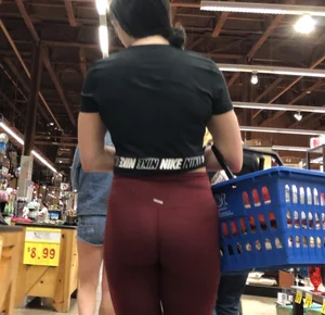 Girl with a nice ass in maroon leggings shopping