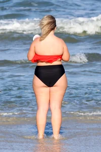 Thick BBW blonde lady in a bikini at the beach