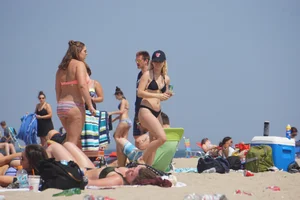 Two thick white girls in bikinis on the beach with big asses