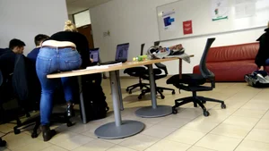 Co-worker bent over table during meeting break