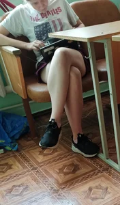 Dorky College Girl in Shorts  Sitting With Crossed Legs With Her Laptop
