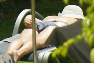 Skinny girl laying out in her bikini has pussy lip slip