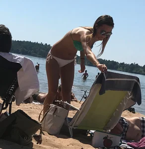 Swedish beach blonde girl in white and green bikini
