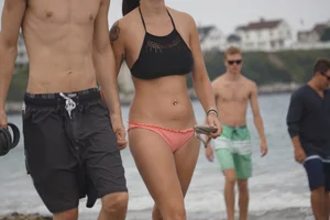 Peach bikini tattood babe on the beach with a nice ass and some camel toe