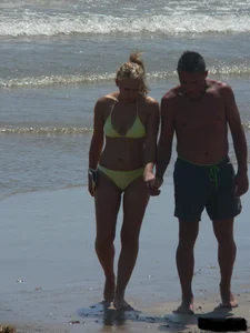 Sexy blonde on the beach in a yellow thong bikini