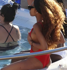 Sexy black girl in red swimsuit at the pool with side boob and a nice ass