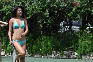 Two sexy girls playing tennis in bikinis