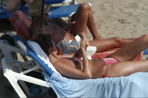 Girls on a nude beach in Sitges, Spain