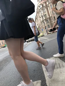 Closeups of a candid girl's legs on a crosswalk