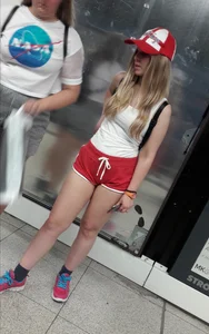 Blonde cheeks hanging out of red shorts on the subway