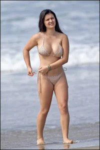 Sexy brunette chick at the beach with big tits and a nice ass in thong bikini