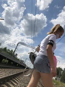 Cute Girl in Denim Shorts Walking Down a Railway Station Gallery