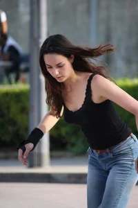 Hot brunette skateboarder in tight jeans and with hard nipples