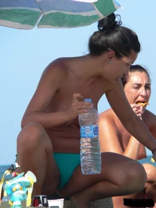 Bunch of sexy babes on the beach topless and in thong bikinis