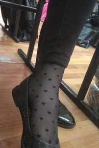 Candid College Teen's Foot Under Table Closeup in Hearts-Patterned Dotted Black Pantyhose