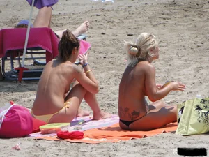 Tattooed blonde with big tits topless and in thong