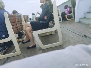 A Sexy Skinny Candid Girl in Flats and a Skirt Sitting With Crossed Legs on a Bench Creepshot