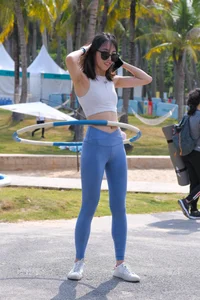 Hula hooping skinny Asian in light blue leggings with vpl