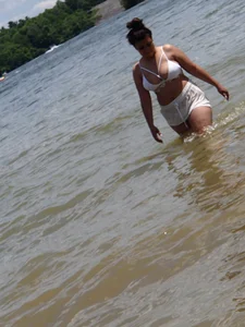 Big boobed brunette on the beach in white bikini
