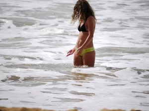 Sexy girl in yellow and black bikini on the beach
