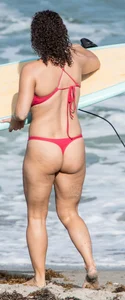 Thick brunette milf on the beach in red thong bikini