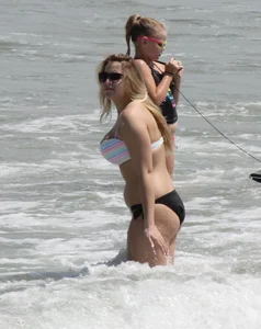 Big boobed thick blonde on the beach in a bikini