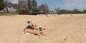 Girl laying out getting sun in a white thong bikini