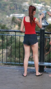 Redhead beauty in short shorts showing some cheeks and panties