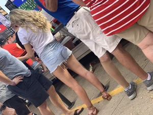 Bunch of girls in various outfits at a Cardinals baseball game