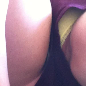 Girl in mini-shorts flashing her yellow panties and pussy while sitting