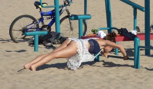 Beach teen in semi thong bikini under see through dress on the beach