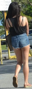 Brunette in short denim shorts showing a little cheek
