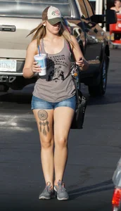 Hot blonde after shopping in short jean shorts and tank top