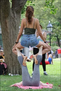 Gymnast or yoga girl in the park in shorts and no bra and even showing some pussy