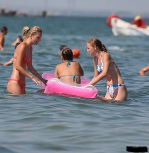 A bunch of sexy beach voyeur babes in bikinis, thongs and topless