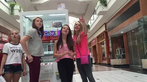 Little blonde teen in grey leggings at the mall with her friends