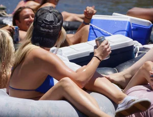 Sexy party girls in bikinis on a lake