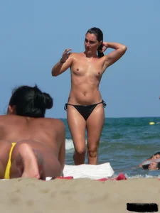 Bunch of sexy babes on the beach topless and in thong bikinis