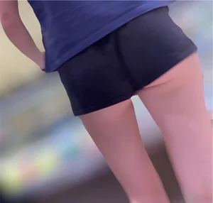 Sexy fit ass in mini shorts and slim legs closeups