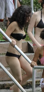 Sexy alt brunette babe in a bikini with piercings and tattoos
