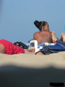 Hot ass topless beach girl with great tits lets her little brother oil up her ass in thong bikini