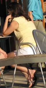 Lady in flop flops while eating showing her feet
