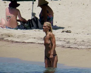 Small boobed topless milf on the beach