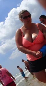 Thick lady on the beach with huge tits