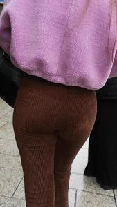 Hot candid girl out in the rain with a nice ass in brown flared leggings