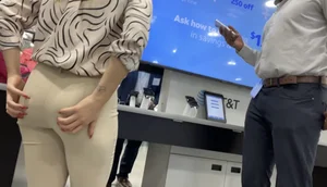 Plus Face shot - Gorgeous AT&T babe in beige pants  touching her ass with long red nails