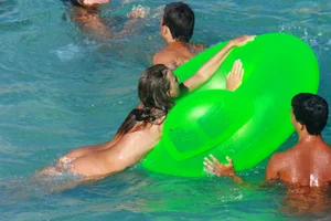 FKK Nudists playing in the water with floater