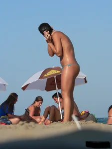 2 topless thonged sexy friends on the beach with great bodies