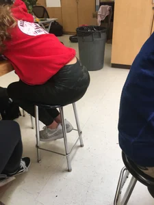 Candid Teen College Girl in Camo Leggings And Sneakers Sitting at the Desk Bent Over
