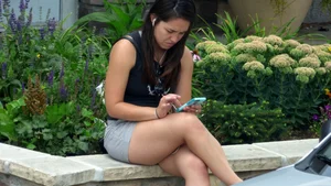 Thick brunette listening to music in shorts